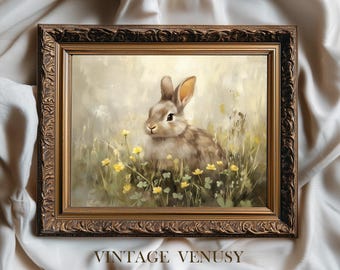 May include: A framed print featuring a detailed painting of a rabbit in a field of yellow flowers. The rabbit has brown and gray fur and is surrounded by green grass. The frame is ornate with a dark brown finish. The text "VINTAGE VENUSY PRINTS" is at the bottom.