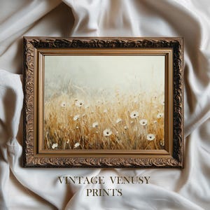 Könnte beinhalten: Ein gerahmter Druck mit einem Feld aus Weizen und weißen Blumen. Das Kunstwerk befindet sich in einem goldenen, verzierten Rahmen. Der Text "VINTAGE VENUSY PRINTS" befindet sich am unteren Rand des Bildes.