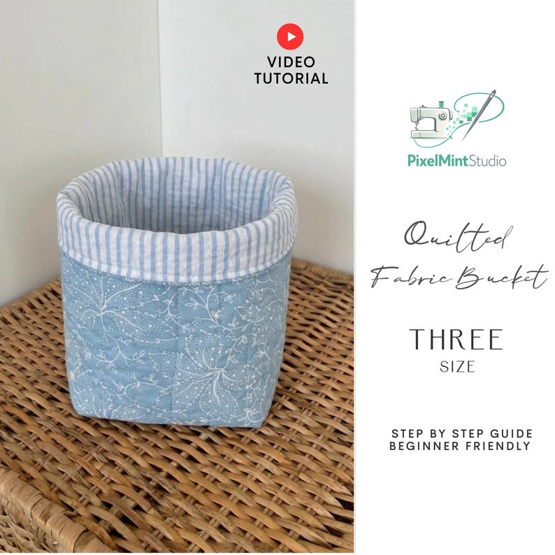 May include: A quilted fabric bucket with a blue floral pattern and a striped interior. The bucket is displayed on a woven surface. The image includes text that says "Video Tutorial", "Quilted Fabric Bucket", and "Three Size".