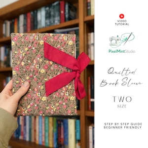 May include: A quilted book sleeve with a floral pattern in shades of brown, pink, and yellow, tied with a red ribbon. The text "Quilted Book Sleeve" and "TWO SIZE" are visible. The image also includes the text "VIDEO TUTORIAL" and "STEP BY STEP GUIDE BEGINNER FRIENDLY".