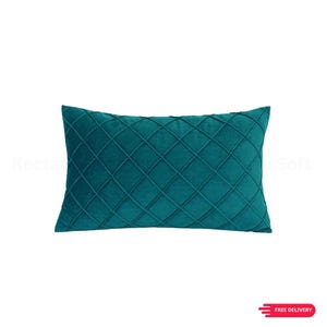 May include: Teal rectangular cushion with a diamond pattern. The cushion is made of a soft, plush material. It is designed for comfort and style. The cushion is a solid teal colour.