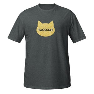 May include: Dark grey t-shirt with a yellow cat-shaped design and the word "TACOCAT" in black. The design is on the front. The shirt has short sleeves and a crew neck. A fun, casual garment.