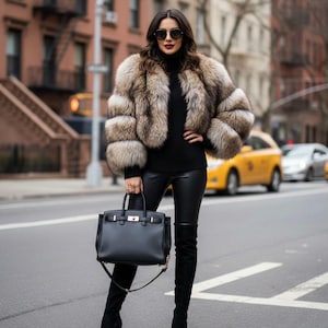 May include: A person wearing a brown and beige fur coat, black turtleneck, black leather trousers, and black over-the-knee boots. They are holding a black handbag with a gold clasp. Sunglasses complete the look. The background shows a city street with yellow taxis.