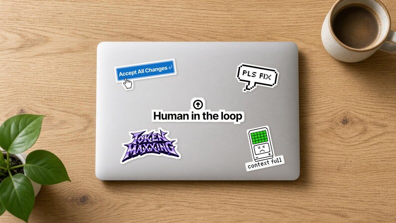May include: A silver laptop lid decorated with five stickers: a blue button reading Accept All Changes, a pixelated speech bubble saying PLS FIX, a central Human in the loop label, a purple Token Maxxing logo, and a green context full icon.