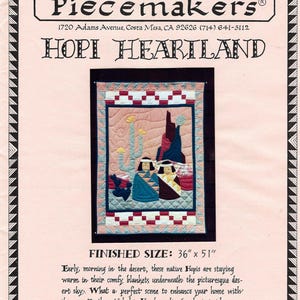 May include: A vintage wall hanging pattern titled "Hopi Heartland" by Piecemakers. The finished size is 36" x 51". The design features a desert scene with Native American figures, cacti, and mountains. The text includes the store's address and copyright information.