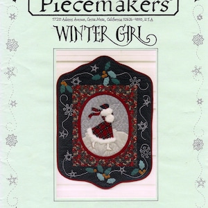May include: A decorative quilt pattern titled "Winter Girl" featuring a girl in a red plaid coat and hat. The quilt is framed with a black border and holly accents. The text "Piecemakers" and address are at the top.