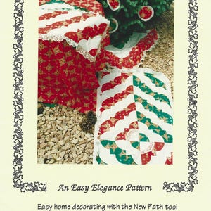 May include: A sewing pattern titled Holiday Ensemble by Elk Mountain Design. The cover features a red, white, and green quilted tree skirt, table runner, and ornaments. Text includes An Easy Elegance Pattern, Easy home decorating with the New Path tool, and Contains instructions for tree skirt, tablerunner, placemat sets, ornaments, & hot pads.