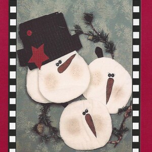 May include: A craft pattern for snowman oven mitts and potholders. The design features three white snowman shapes with black top hats, carrot noses, and twig arms. The oven mitts are 14 inches and the potholders are 8 inches.