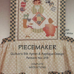 May include: A beige and black checkered bib apron with a patchwork design. The apron features a whimsical illustration of a figure holding a quilt, with the text "PIECEMAKER" and "Quilter's Bib Apron & Applique Design" printed on it.