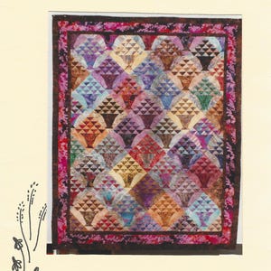 May include: A quilt pattern titled Batik Bouquet 85 x 102 60410 by Prairie's Edge Patchworks. The quilt features a repeating basket motif in various batik fabric colors including blue, purple, orange, and green, surrounded by a dark floral border.