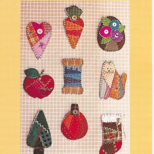 Pode incluir: Um fundo amarelo com a palavra "Sweetpea" no topo. Abaixo, nove projetos de patchwork, incluindo um coração, uma cenoura, uma maçã, uma bobina, um gato, uma árvore de Natal, uma abóbora e uma meia. O texto "Quilter's Pins" e "A collection of 9 foundation-pieced projects" estão na parte inferior.