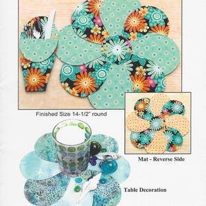 May include: A floral-themed table setting pattern with reversible mats and a silverware case. The mats are approximately 14.5 inches in diameter and feature a flower petal design with teal, orange, and black floral patterns. The text "Flower Petals" and "Table Settings" are visible.