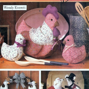May include: A Butterick craft pattern featuring various fabric craft projects. The image showcases a large stuffed chicken, a duck, and a smaller chicken, all made from patterned fabric. Additional crafts include a wreath with duck figures and mouse figures.