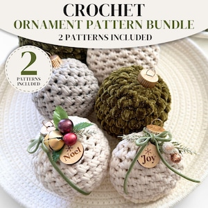 May include: A crochet ornament pattern bundle featuring four spherical ornaments in cream, grey, and olive green. Two ornaments feature wooden tags with the text Noel and Joy, decorated with small bells, berries, and green ribbon accents.