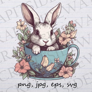 May include: A white rabbit sits in a blue teacup with a white saucer. The teacup is surrounded by pink and white flowers and green leaves.