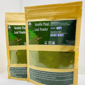 May include: Two brown paper pouches of Insulin Plant Leaf Powder. Each pouch has a green and white label with the product name and a green leaf graphic. The weight is 100g, and the expiry date is 03/05/2026.