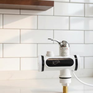 以下が含まれることがあります： 白と黒のZB Power瞬間湯沸かし器とクロム蛇口。ユニットは白いタイルの壁に対して白い表面に取り付けられています。灰色の鉢に入った小さな多肉植物が木製の棚に置かれています。