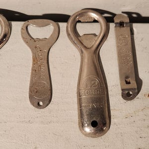 May include: Six vintage bottle openers, including a Schlitz, a 12 Horse, and a Labatt, all with different designs and branding.