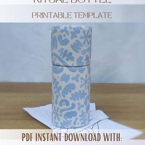 Puede incluir: Una botella ritual cilíndrica con un patrón abstracto azul claro sobre un fondo blanco. El texto RITUAL BOTTLE PRINTABLE TEMPLATE y PDF INSTANT DOWNLOAD WITH: TEMPLATE. STEP BY STEP INSTRUCTIONS ESPAÑOL + ENGLISH es visible.