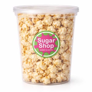 May include: A clear plastic container filled with caramel popcorn. The container has a clear lid and a circular sticker with the text "Sugar Shop Candy & Gifts" in pink and green. The popcorn is light brown and appears freshly made.