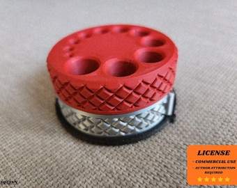 May include: A red and silver 3D-printed tool holder. The top is red with multiple holes of varying sizes. The base is silver with a diamond pattern. The holder is designed to organise tools.