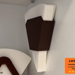 May include: A dark brown, geometric paper filter holder mounted on a light gray wall. The holder is filled with white paper filters. A second, similar holder is visible below. The image includes a license notice in the bottom right corner.