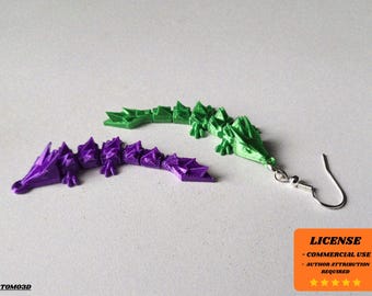 May include: A pair of dragon-shaped earrings in green and purple. The earrings are made of a 3D-printed material and feature a detailed, textured design. One earring is attached to a silver-colored ear wire. The image also includes a license notice.