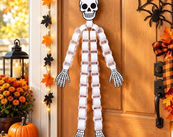 Könnte beinhalten: Eine hängende Skelettdekoration aus weißen Papierkettengliedern. Die Figur besteht aus einem flachen, illustrierten Totenkopf sowie passenden skelettierten Händen und Füßen in Schwarz und Weiß an einem langen Papierkettenkörper.