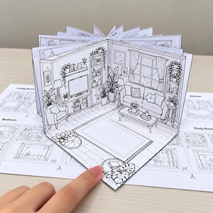 May include: A 3D pop-up paper craft book featuring black and white line art illustrations of various rooms including a living room, kitchen, bedroom, and study room. The central page displays a detailed living room scene with a sofa, rug, and plants.
