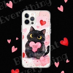 May include: A clear phone case featuring a watercolor design with a black cat holding a pink heart that says "MINE". The case has a pink and white background with scattered hearts. The words "Black Cat Everything" are in the background.