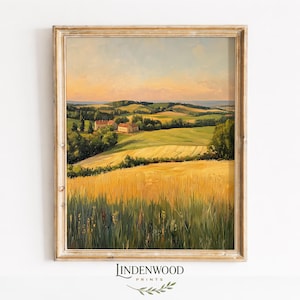 Pode incluir: Pintura de paisagem emoldurada que retrata um campo de trigo dourado sob um céu quente ao pôr do sol. Colinas verdes e edifícios são visíveis ao longe. A obra de arte está em uma moldura de madeira dourada. O texto "LINDENWOOD PRINTS" está na parte inferior.