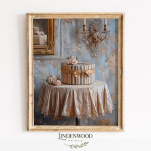 May include: A framed print of a still life painting. A round striped box with a gold ribbon sits on a small table covered with a lace cloth. Pink roses are arranged on the table and box. The background features a blue wall with a chandelier and a framed painting.