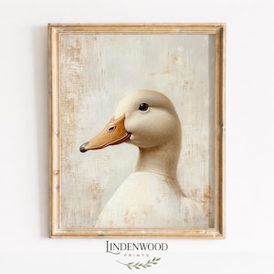 May include: A framed print featuring a close-up of a white duck's head and neck. The duck has a brown beak and dark eye. The background is a textured, off-white color. The frame is a light brown color. The print is from Lindenwood Prints.