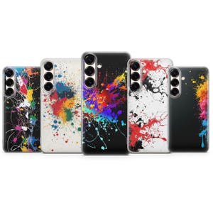 May include: Five phone cases with colorful paint splatter designs. The cases feature a variety of colors, including red, blue, yellow, and green, against black and white backgrounds. Each case has a camera cutout.
