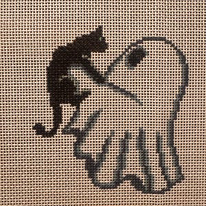May include: A cross-stitch embroidery on a beige grid fabric featuring a black cat sitting on top of a white ghost with a dark gray outline. The ghost has two dark gray circular eyes and a wavy bottom edge, while the cat is depicted in profile.