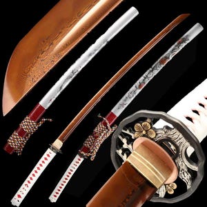 May include: Two Japanese katana swords with brown blades, white handles, and decorative silver and red accents. The blades have intricate designs, and the handles are wrapped with red and white cord. The sword guards feature floral and animal motifs.
