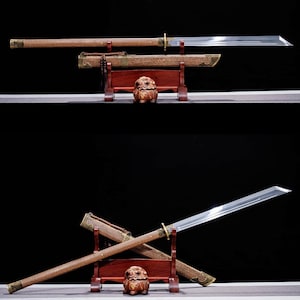 May include: Two Japanese-style swords with wooden handles and sheaths, displayed on a wooden stand. The blades are silver and the handles are brown. The sheaths are also brown with gold accents. A small wooden carving sits below the swords.