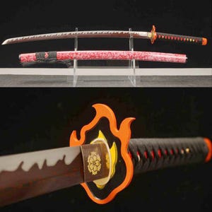 May include: A Japanese-style katana sword with a red and black handle and a decorative orange flame-shaped guard. The blade has a distinctive wavy edge and is displayed with its red scabbard.