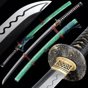 May include: An assortment of Japanese katana swords. The blades have a silver finish with a wavy edge. The handles are black with gold accents and green sheaths. The swords are displayed against a black background.