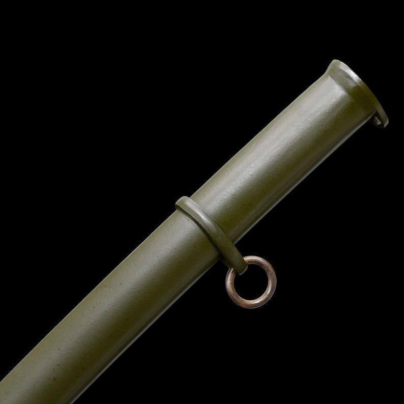 May include: Olive green metal scabbard with a circular ring and a band. The scabbard has a cylindrical shape and a slightly flared opening. The background is black.