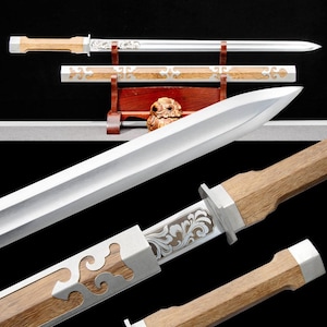 May include: A detailed image of a traditional sword with a polished steel blade and a wooden handle. The handle and scabbard feature decorative metal accents. The sword is displayed on a wooden stand, showcasing its craftsmanship.