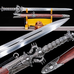 May include: A detailed image of a decorative sword with a silver blade and ornate handle. The handle features dragon motifs and intricate carvings. The sword is displayed with its wooden scabbard, showcasing a blend of metal and wood.