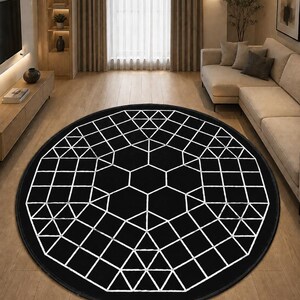 May include: A large circular area rug featuring a solid black background with a white geometric pattern composed of interconnected hexagons, triangles, and squares that radiate from the center toward the outer edge of the circular rug.