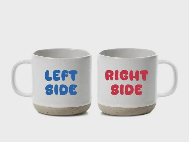 May include: Two white ceramic mugs with a speckled beige base. One mug has the words "LEFT SIDE" in blue, and the other has "RIGHT SIDE" in red. Both mugs have a white handle.