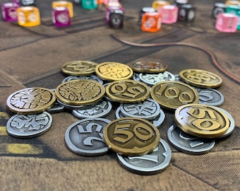 May include: A collection of metal gaming coins in gold and silver tones, featuring embossed numbers like 25, 50, and 100, alongside various geometric and skull designs. In the blurred background, numerous colorful translucent dice are scattered.