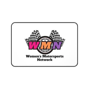 May include: Rectangular white mousepad with a black border. The design features the letters "WMN" in pink, orange, and purple, with a black and white checkered flag on each side. Below the letters is the text "Women's Motorsports Network."
