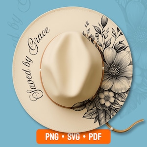 Könnte beinhalten: Cremefarbener Fedora-Hut mit floralem Design und dem Schriftzug "Saved by Grace" in Schwarz. Der Hut hat ein braunes Lederband und einen Kinnriemen. Das Bild enthält auch den Text "PNG • SVG • PDF".