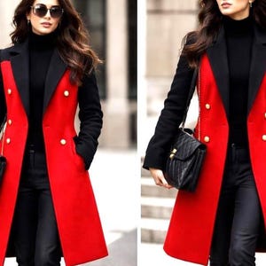 May include: A long, double-breasted coat featuring a vibrant red body with contrasting black sleeves and lapels. The coat is adorned with gold-toned buttons and is worn over a black turtleneck sweater and black trousers, paired with a black handbag.