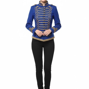 May include: A royal blue military-style jacket with gold-colored trim and decorative rope detailing. The jacket features a high collar and multiple gold buttons. The person is wearing black pants and black boots. The jacket is a statement piece.