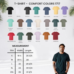 May include: A display of Comfort Colors 1717 t-shirts in various colors, including black, white, and blue jean. The image also shows a measurement chart with sizes ranging from S to 2XL, with widths from 18 1/4 to 26 inches and lengths from 26 3/5 to 31 3/5 inches.